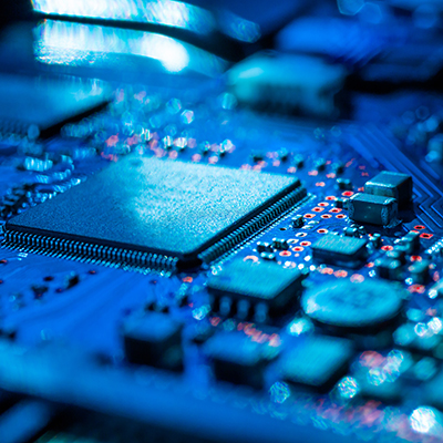 Blue tinted closeup of processor on circuit board.
